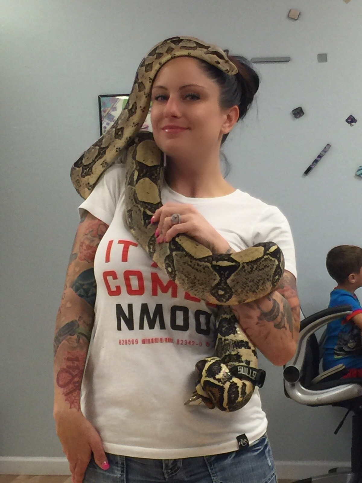 pet boa constrictor sizes up owner