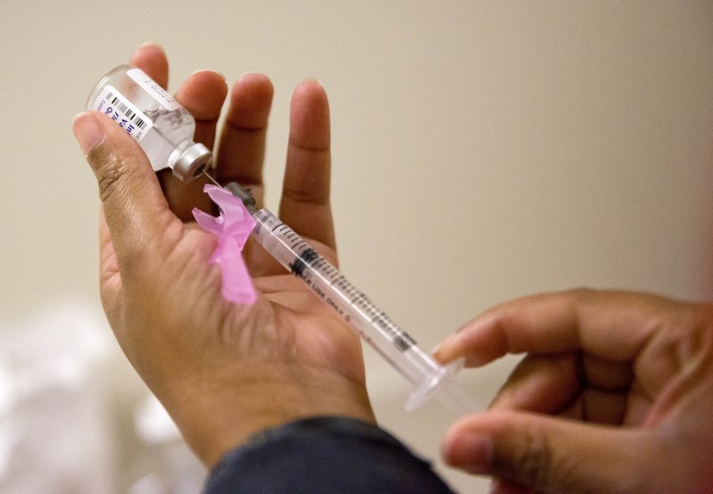 Flu season vaccination. Photo via AP.