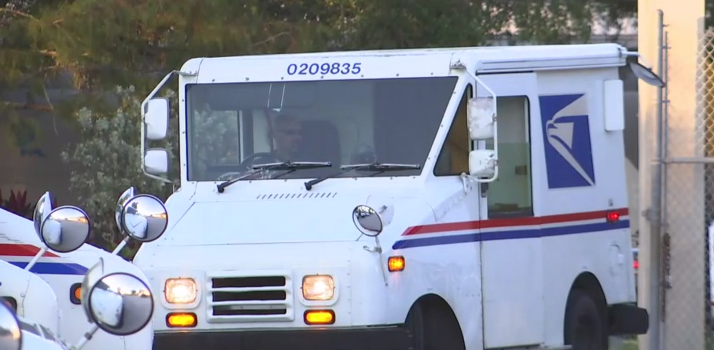 Several U.S. Postal Service vehicles. Photo via WINK News.