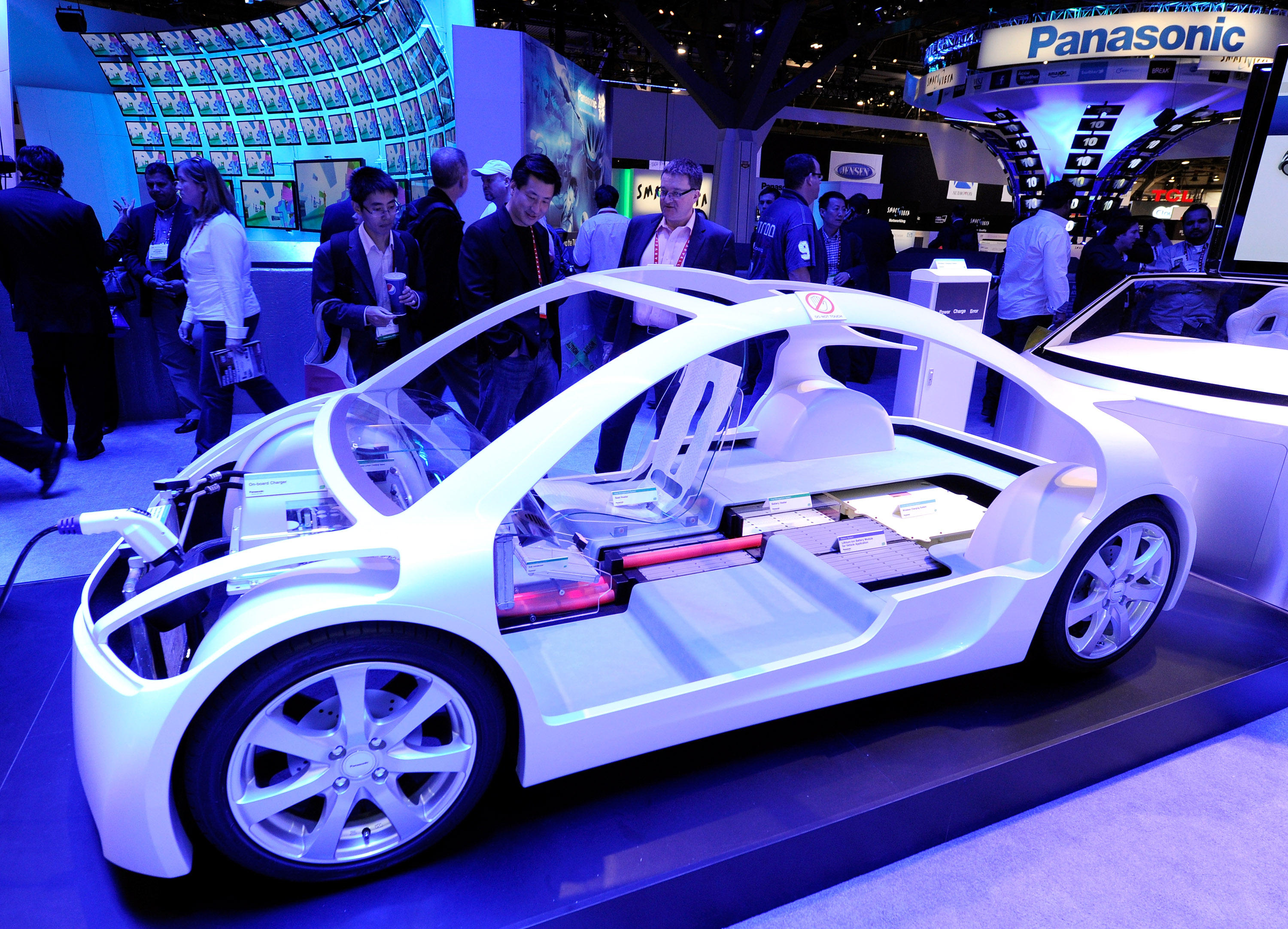 LAS VEGAS, NV - JANUARY 12: Attendees look at components for an electric vehicle at the Panasonic booth at the 2012 International Consumer Electronics Show at the Las Vegas Convention Center January 12, 2012 in Las Vegas, Nevada. CES, the world's largest annual consumer technology trade show, runs through January 13 and features more than 3,100 exhibitors showing off their latest products and services to about 140,000 attendees. Photo via AP.