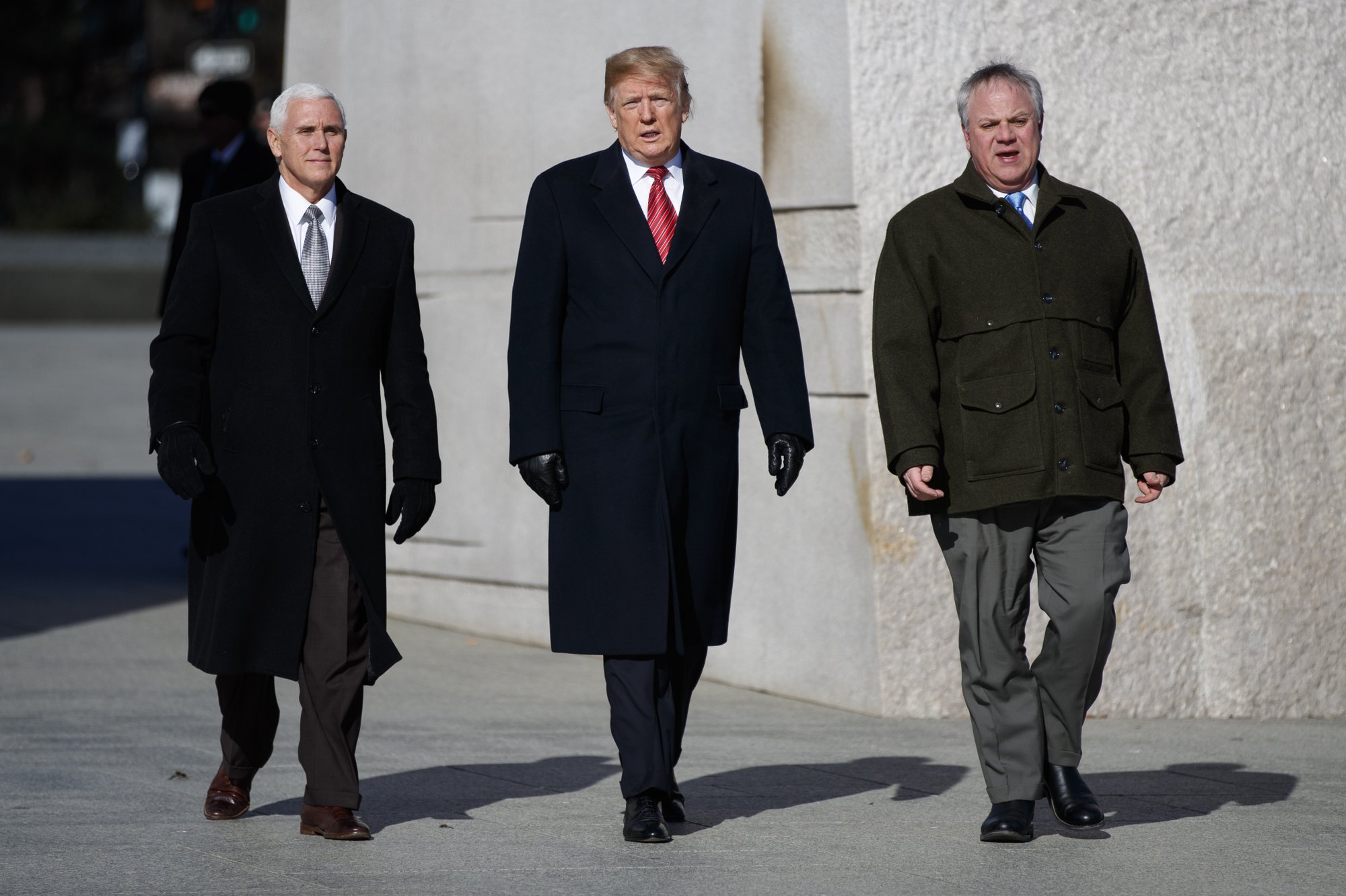 President Donald Trump, center, Vice President Mike Pence, left, escorted by Acting Interior Secretary David Bernhardt, right, visit the Martin Luther King Jr. Memorial, Monday, Jan. 21, 2019, in Washington. (AP Photo/ Evan Vucci)