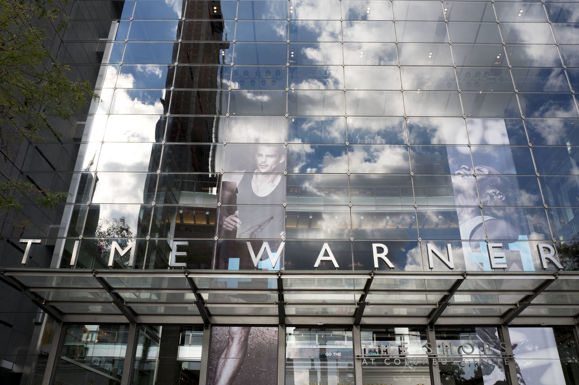 FILE - In this Oct. 24, 2016, file photo, clouds are reflected in the glass facade of the Time Warner building in New York. A federal appeals court on Tuesday, Feb. 26, 2019 upheld AT&T's $81 billion takeover of Time Warner, approving one of the biggest media deals on record in the face of opposition from the Trump administration. The combination of one of the country's largest wireless carriers and TV providers with a major TV and movie company has already reshaped the media landscape. (AP Photo/Mark Lennihan, File)
