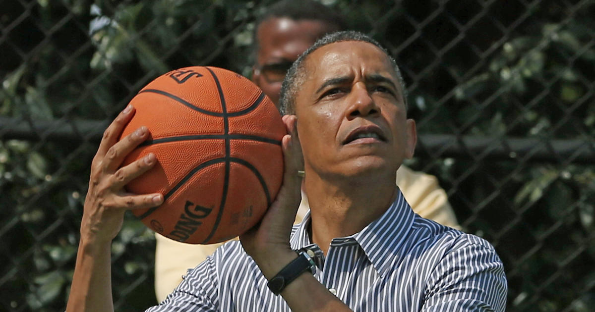 Former President Barack Obama plays basketball. (CBS News photo)