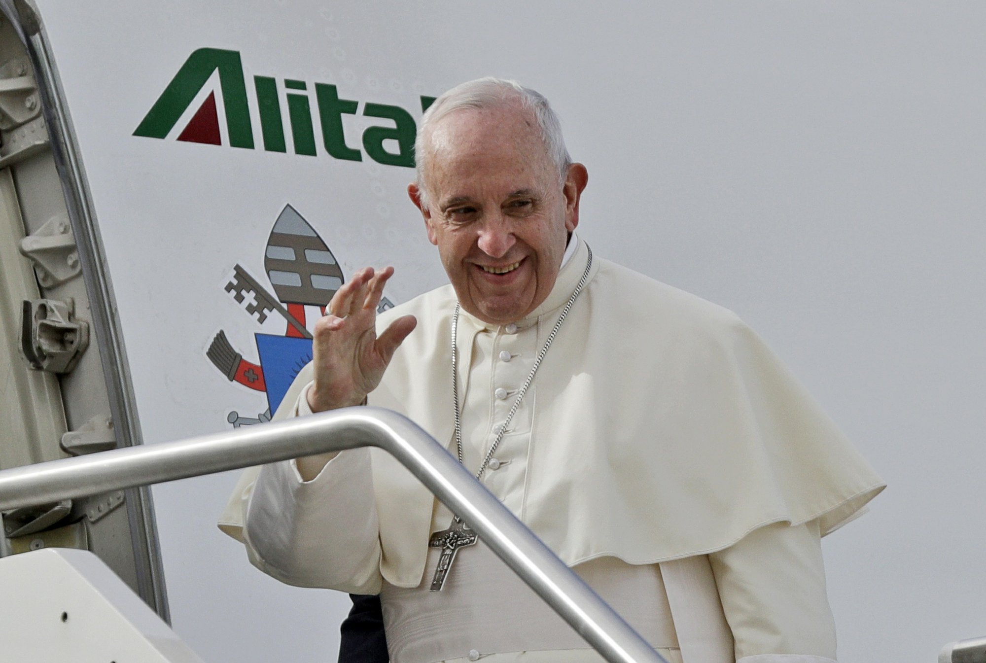 Pope Francis waves as he boards the airplane for Abu Dhabi, United Arab Emirates, at Rome's Fiumicino International airport, Sunday, Feb. 3, 2019. Francis made an urgent appeal for an end to the humanitarian crisis in Yemen on Sunday as he embarked on the first-ever papal trip to the Arabian Peninsula, where he is seeking to turn a page in Christian-Muslim relations while also ministering to a unique, thriving island of Catholicism. (AP Photo/Gregorio Borgia)