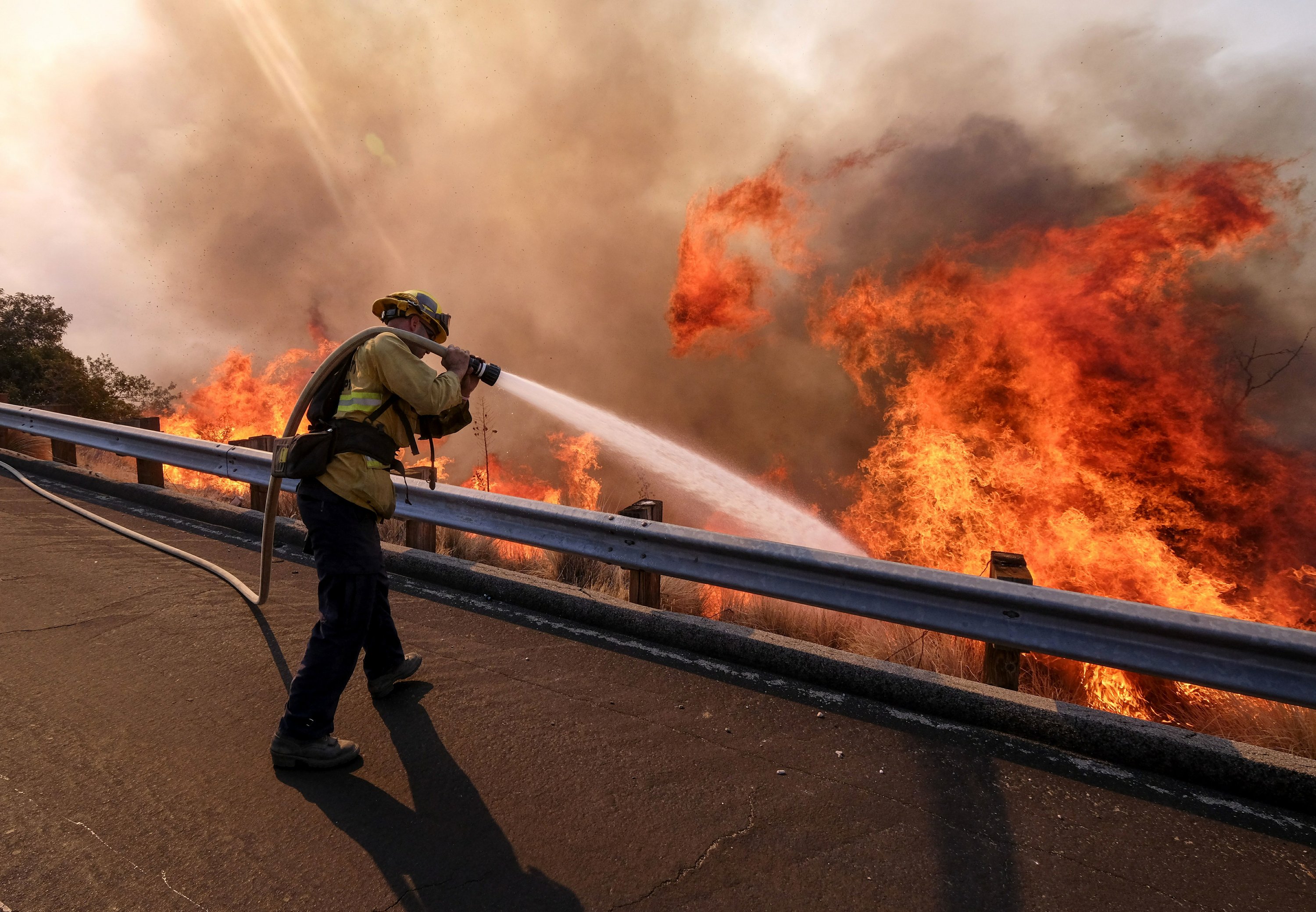 Firefighter battles the flames. (Credit: AP)