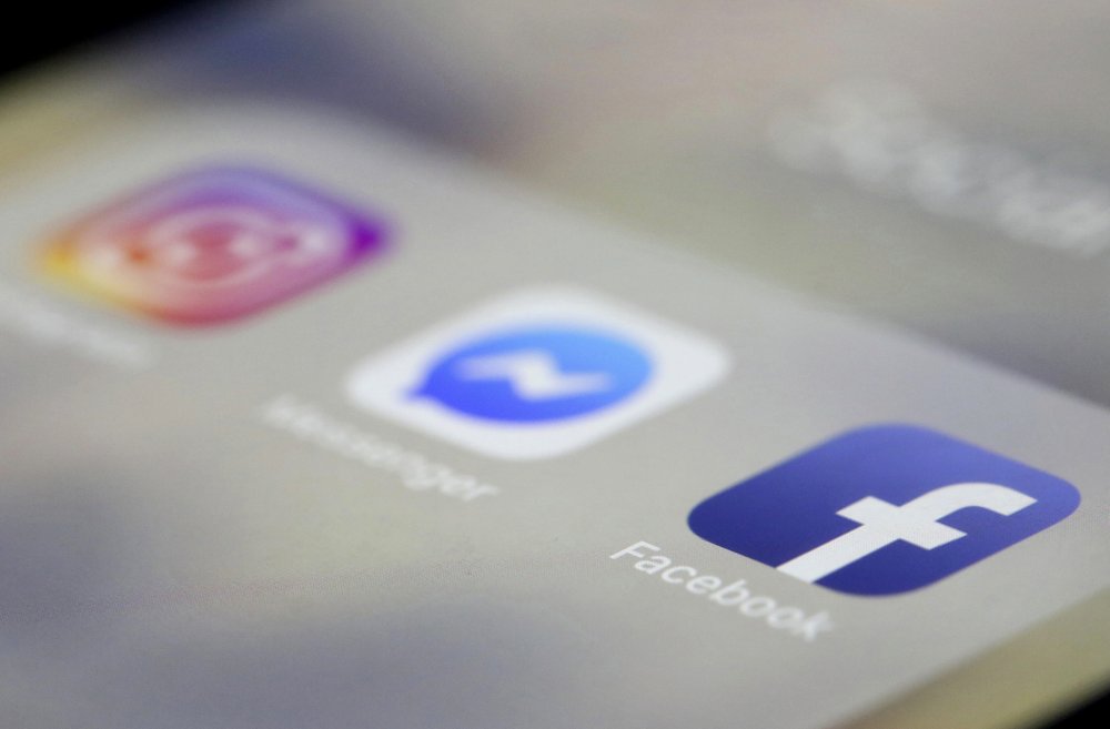 FILE- In this March 13, 2019, file photo Facebook, Messenger and Instagram apps are are displayed on an iPhone in New York. Facebook said Wednesday, March 27, that it is broadening its definition of hate speech to apply to 