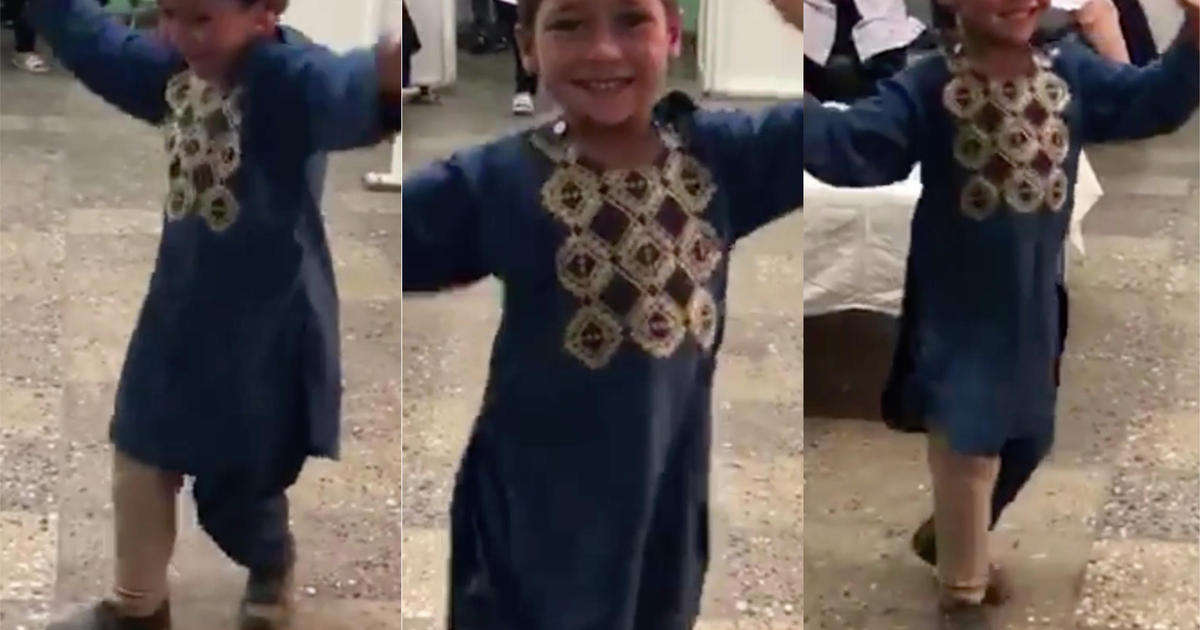 Boy who lost leg from landmine in Afghanistan dances after receiving prosthetic limb. (Credit: CBS News)