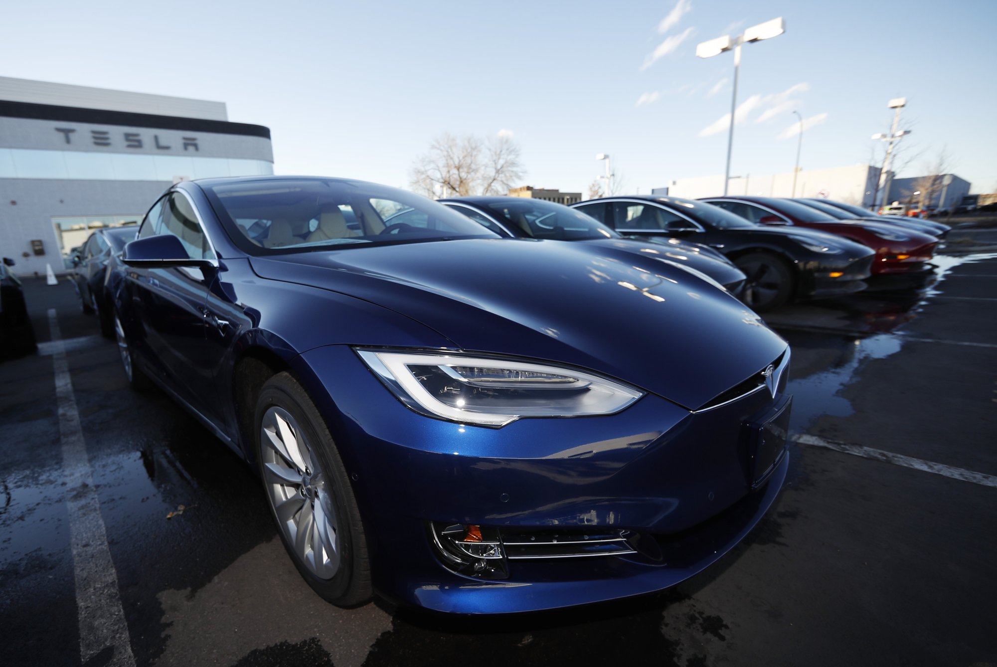 FILE - In this Sunday, Feb. 3, 2019, file photograph, an unsold 2019 S75D sits at a Tesla dealership in Littleton, Colo. Rising trade tensions have sparked worries about the 17 exotic-sounding rare minerals needed for high-tech products like robotics, drones and electric cars. China recently raised tariffs to 25% on rare earth exports to the U.S. and has threatened to halt exports altogether after the Trump administration raised tariffs on Chinese products and blacklisted telecommunications giant Huawei. (AP Photo/David Zalubowski, File)