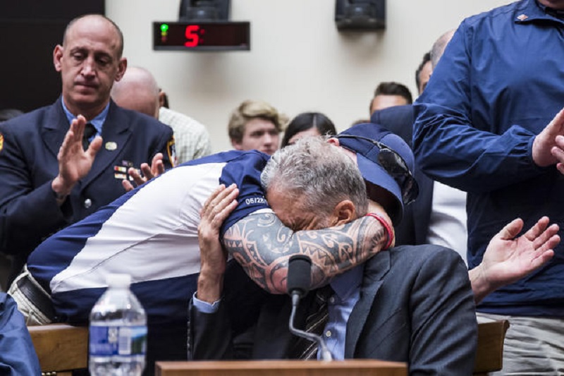 First responder hugs Jon Stewart. (Credit: CBS News)
