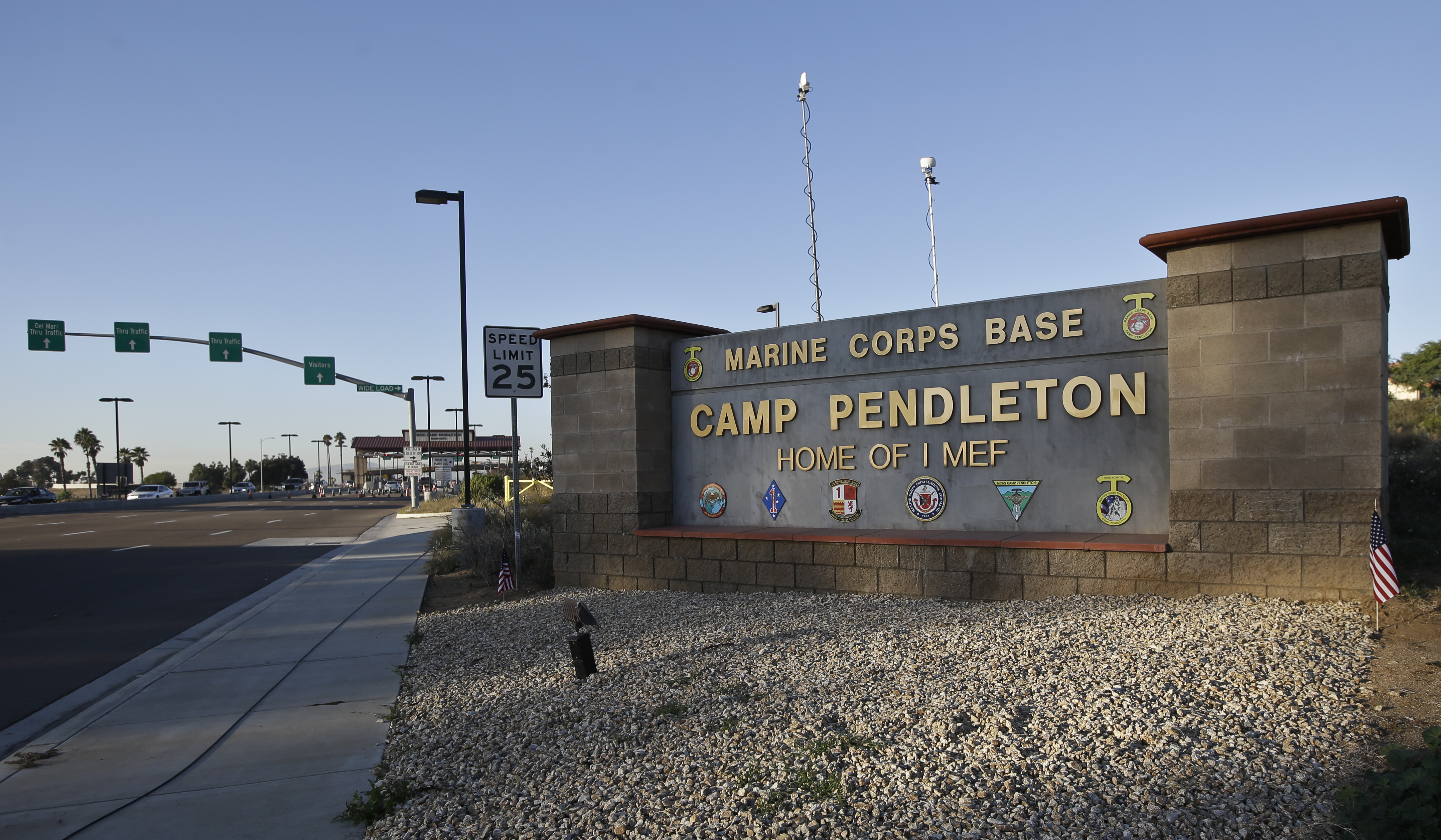 FILE: Vehicles file through the main gate of Camp Pendleton Marine Base on Wednesday, Nov. 13, 2013, at Camp Pendleton, Calif.(AP Photo/Lenny Ignelzi/FILE)