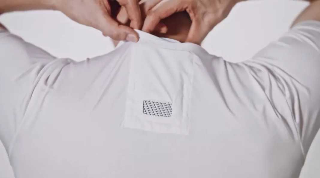 Man places device on 'air conditioner' shirt. (Credit: Sony)