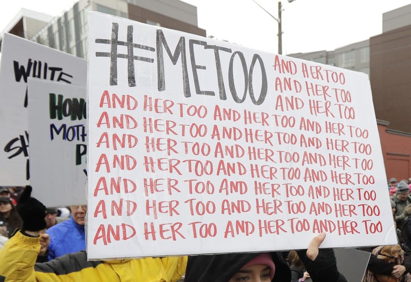 FILE - In this Jan. 20, 2018 file photo, a marcher carries a sign with the popular Twitter hashtag #MeToo used by people speaking out against sexual harassment as she takes part in a Women's March in Seattle. According to a study published Monday, Sept. 16, 2019, the first sexual experience for many U.S. women was forced or coerced intercourse in their early teens, encounters that for some may have had lasting health repercussions. (AP Photo/Ted S. Warren, File)