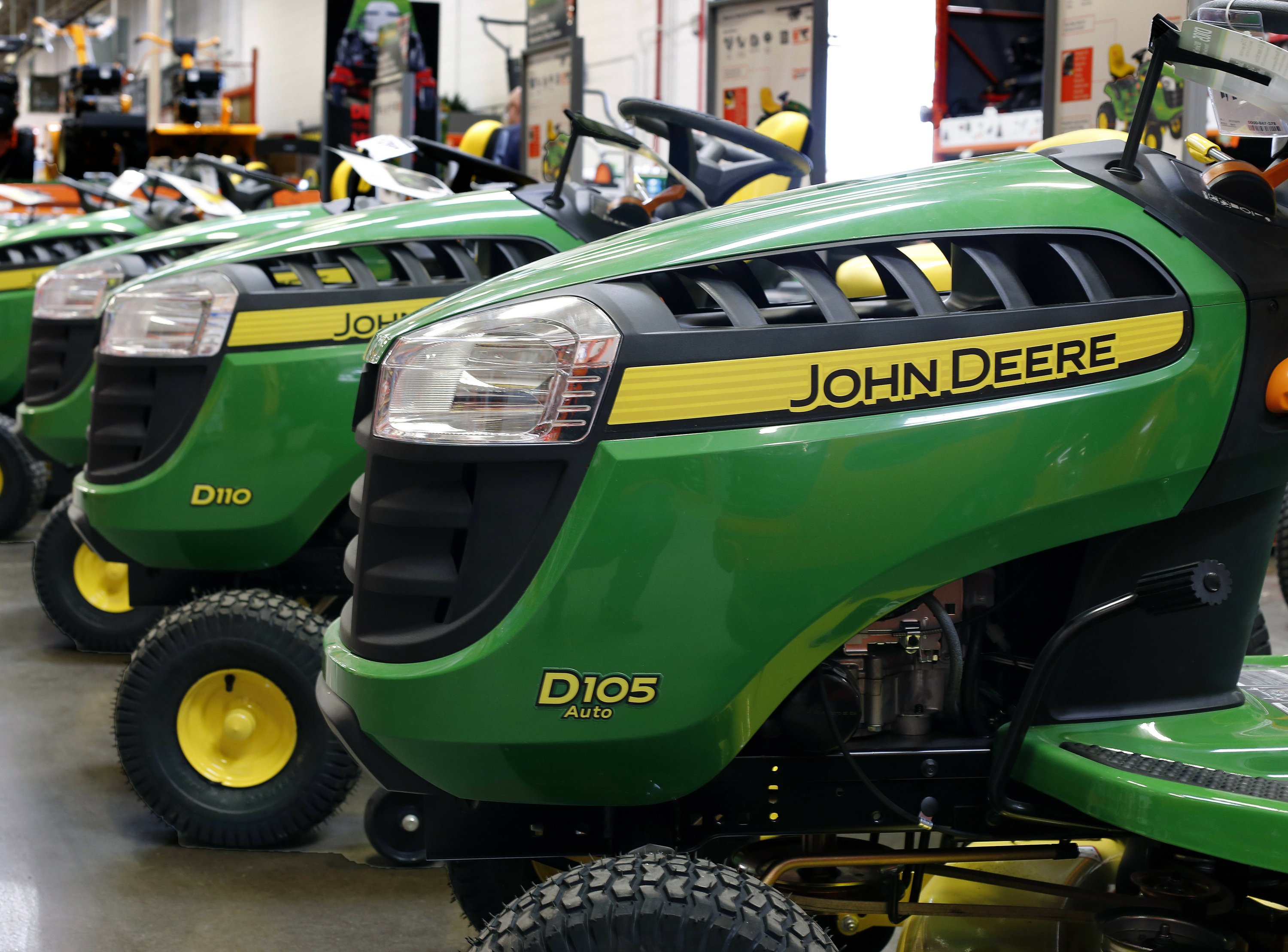 FILE - In this March 23, 2015, file photo, John Deere lawn tractors are on display at a Home Depot in Robinson Township, Pa. Wall Street is flooding into the agricultural sector on reports that the Trump administration is preparing a plan that would send billions in aid to U.S. farmers hurt by tariffs. CF Industries Holding and Mosaic Company both traded up more than 3 percent, while Deere & Co. shot up more than 4 percent after news of the aid package was leaked to The Associated Press by two people briefed on the plan. (AP Photo/Gene J. Puskar, File)