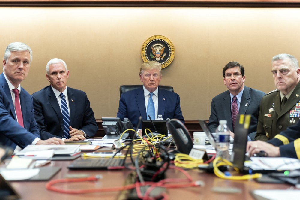 In this image released by the White House, President Donald Trump is joined by Vice President Mike Pence, second from left, national security adviser Robert O’Brien, left; Secretary of Defense Mark Esper, second from right, and Chairman of the Joint Chiefs of Staff Army Gen. Mark A. Milley, right, Saturday, Oct. 26, 2019, in the Situation Room of the White House monitoring developments in the U.S. Special Operations forces raid that took out Islamic State leader Abu Bakr al-Baghdadi.. (Shealah Craighead/White House via AP)