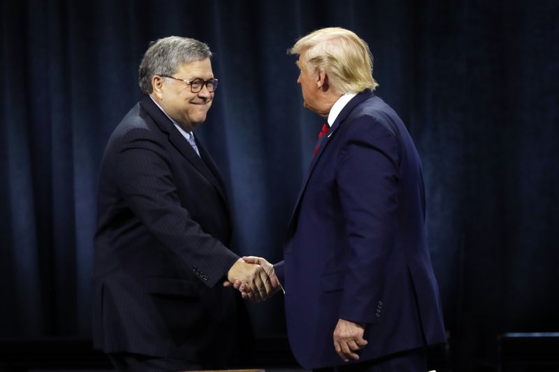 President Donald Trump shakes hands with Attorney General William Barr before Trump signed an executive order creating a commission to study law enforcement and justice at the International Association of Chiefs of Police Convention Monday, Oct. 28, 2019, in Chicago. (AP Photo/Charles Rex Arbogast)