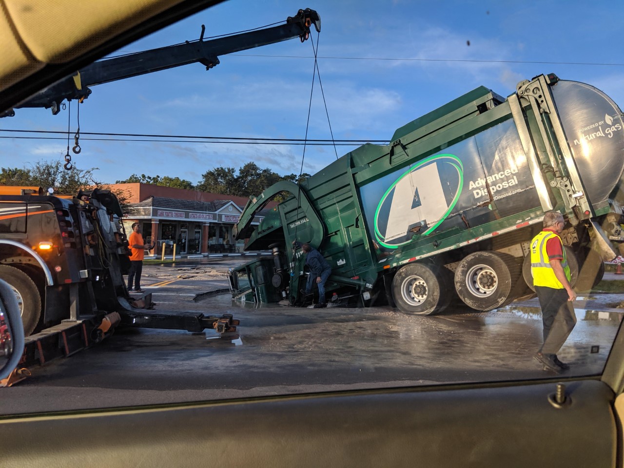 Garbage truck falls in sinkhole caused by water main break along U.S. 41