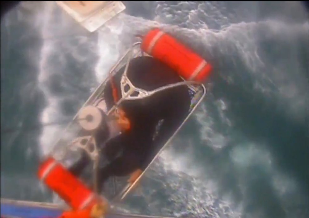 In this Saturday, Dec. 21, 2019, video image released by the U.S. Coast Guard shows a man, wearing a full-body wetsuit, being hoisted up from the boat into the helicopter near Santa Rosa Island, one of the Channel Islands in Southern California. A shark reportedly bit a surfer Saturday afternoon in a "truly terrifying situation," the Coast Guard said. The 37-year-old man had been surfing near Santa Rosa Island, one of the Channel Islands, during the attack, according to a news release. (U.S. Coast Guard Los Angeles via AP)
