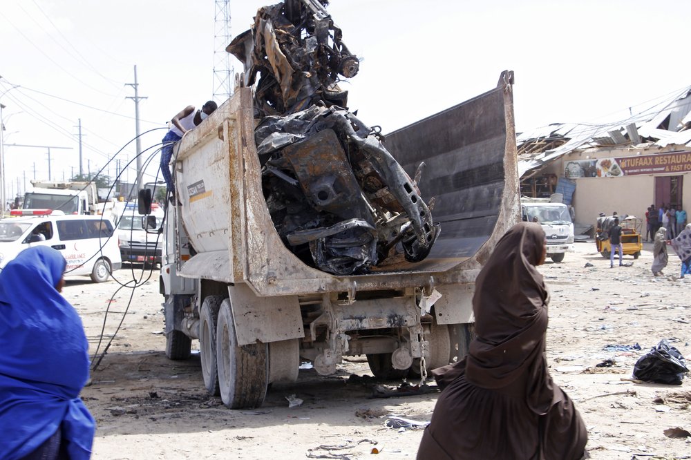 A truck carries wreckage of a car used in a car bomb in Mogadishu, Somalia, Saturday, Dec. 28, 2019. A truck bomb exploded at a busy security checkpoint in Somalia's capital Saturday morning, authorities said. It was one of the deadliest attacks in Mogadishu in recent memory. (AP Photo/Farah Abdi Warsame)