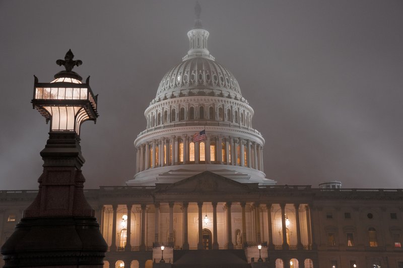 The U.S. Capitol in Washington is shrouded in mist, Friday night, Dec. 13, 2019. This coming week’s virtually certain House impeachment of President Donald Trump will underscore how Democrats and Republicans have morphed into fiercely divided camps since lawmakers impeached President Bill Clinton.(AP Photo/J. Scott Applewhite)