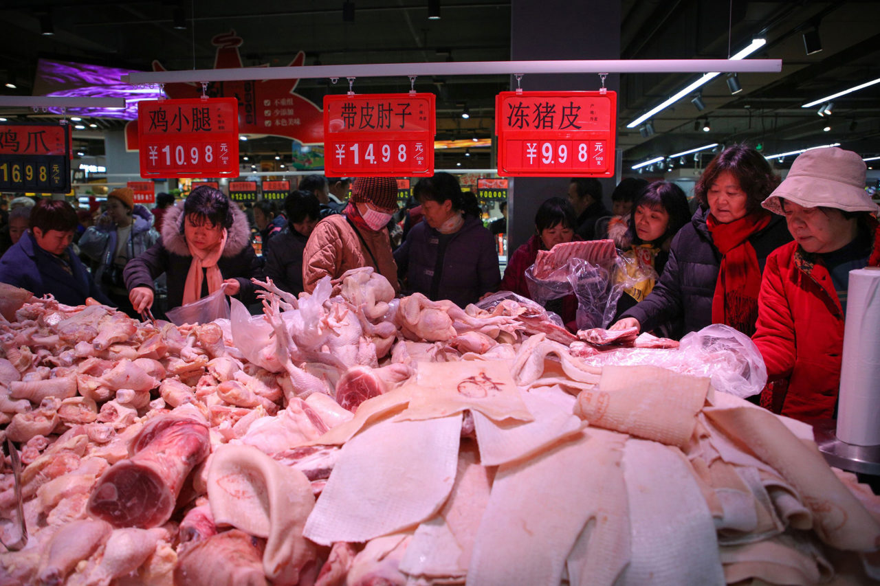 This photo taken on December 19, 2019 shows people trying to buy meat at a newly-opened supermarket in Binzhou, in China's eastern Shandong Province. - The supermarket offered 3 tonnes of pork at discounted prices as a promotion. Pork prices in China have doubled this year following an outbreak of African swine fever. (Photo by STR / AFP) / China OUT (Photo by STR/AFP via Getty Images)