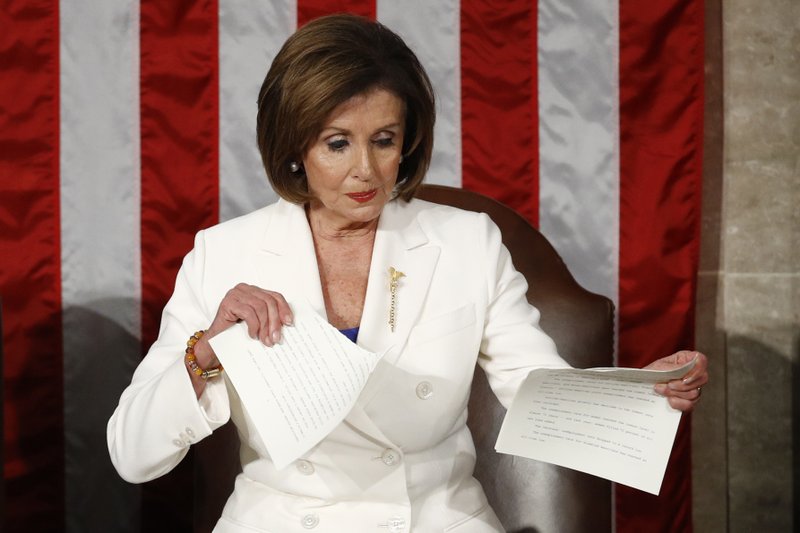 FILE - In this Tuesday, Feb. 4, 2020, file photo, House Speaker Nancy Pelosi, of California, tears her copy of President Donald Trump's State of the Union address after he delivered it to a joint session of Congress on Capitol Hill in Washington. (AP Photo/Patrick Semansky, File)