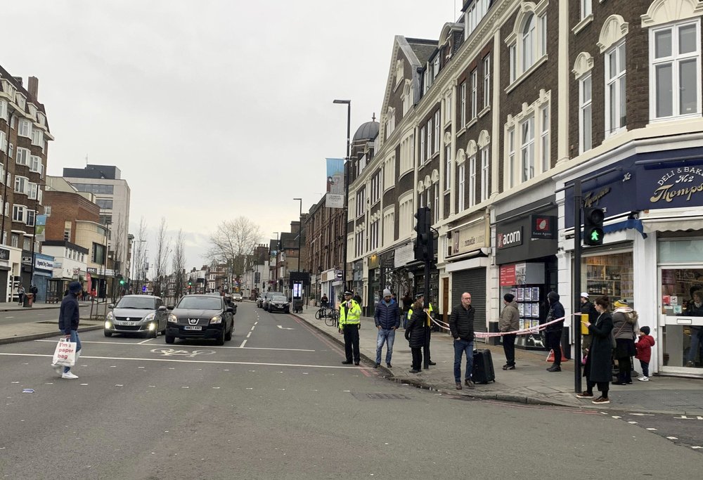 Police attend the scene after an incident in Streatham, London, Sunday Feb. 2, 2020. London police say officers shot a man during a “terrorism-related incident” that involved the stabbings of “a number of people.” (Isobel Frodsham/PA via AP)