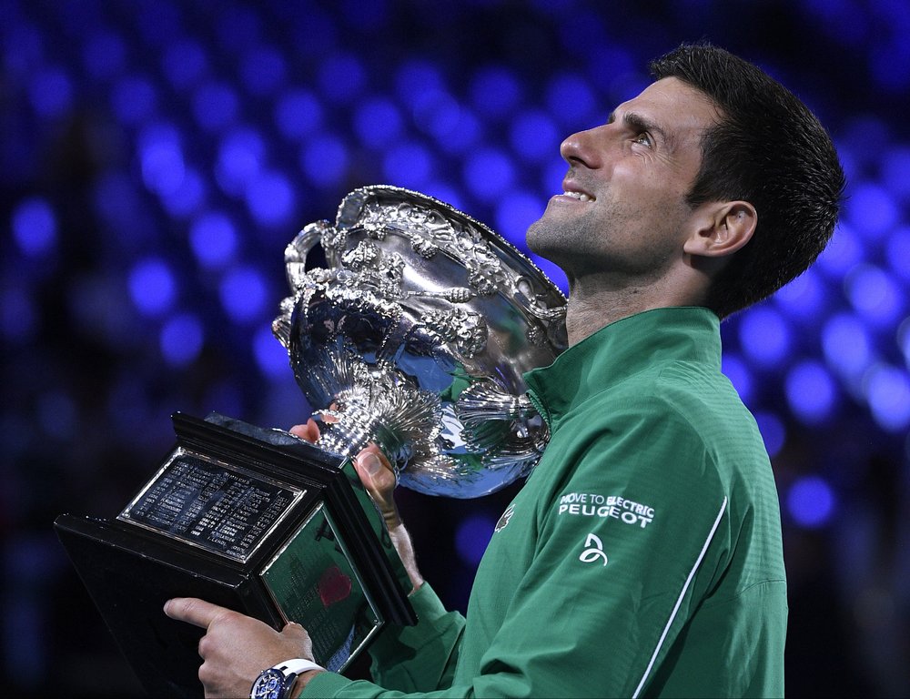 Serbia's Novak Djokovic holds the Norman Brookes Challenge Cup after defeating Austria's Dominic Thiem in the final of the Australian Open tennis championship in Melbourne, Australia, Monday, Feb. 3, 2020. (AP Photo/Andy Brownbill)
