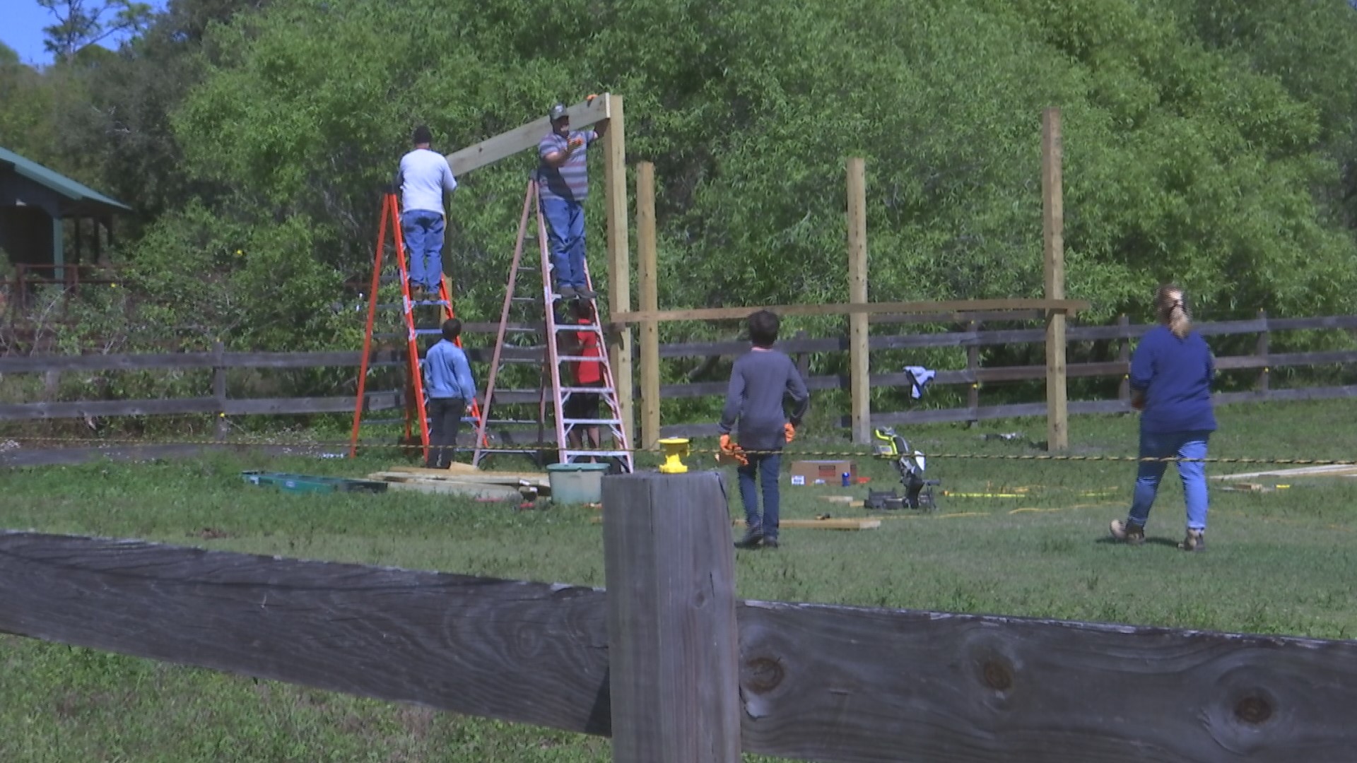 Max Mangone leads volunteers creating horse shelters at Miles Ranch as his Eagle Scout project. (Credit: WINK News)